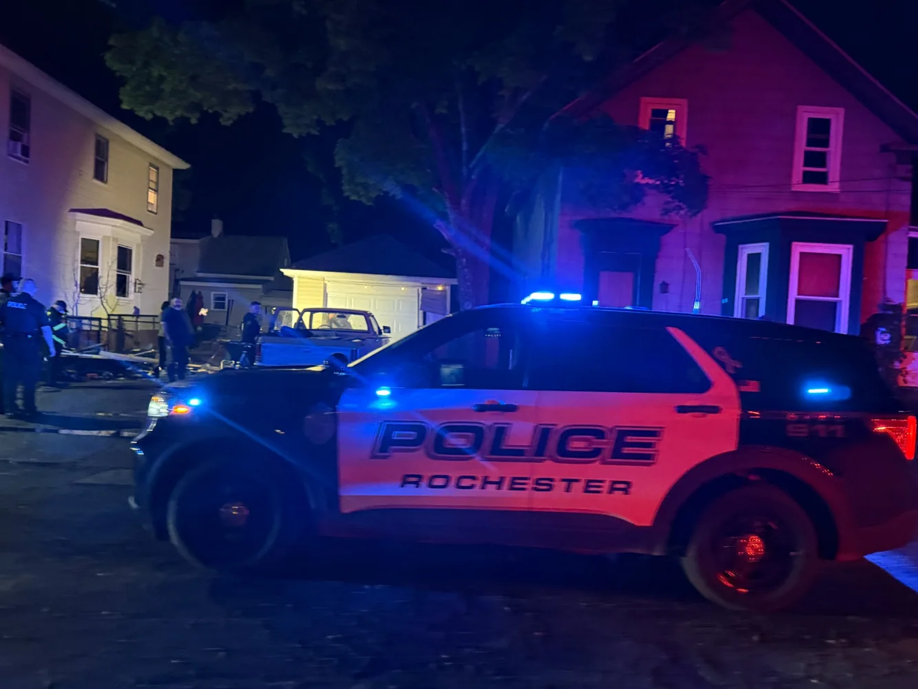 Marked Rochester Police vehicle with emergency lights at night